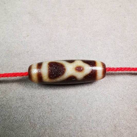Kubera Dzi Bead - Tibetan dzi bead, front view