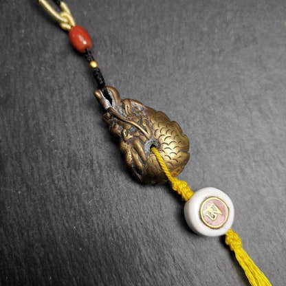 Amulet, Dragon Charm Pendant - Tibetan Buddhist amulet, close-up detail