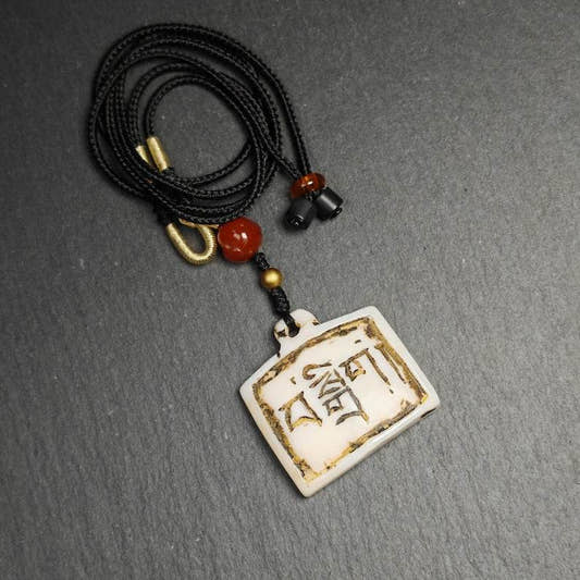 Amulet Badge with Tibetan Letters - Tibetan Buddhist amulet, front view