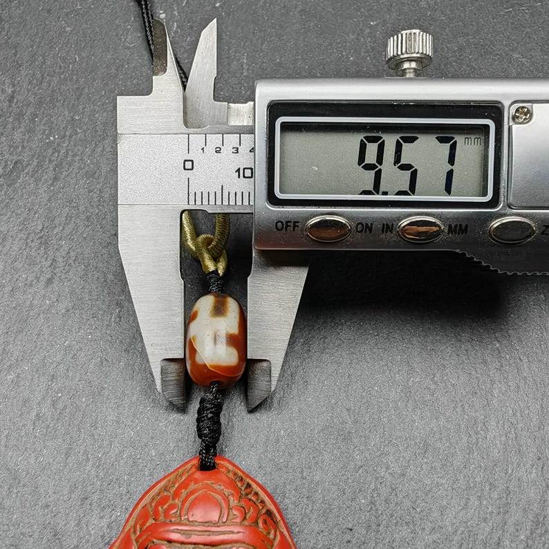 Old Cinnabar Mahakala Amulet with Dzi Bead - Tibetan dzi bead, size reference