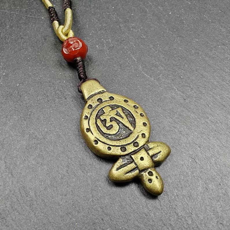 Tibetan Buddhism Amulet - Vajra Pendant with OM Symbol - Tibetan Buddhist amulet, front view