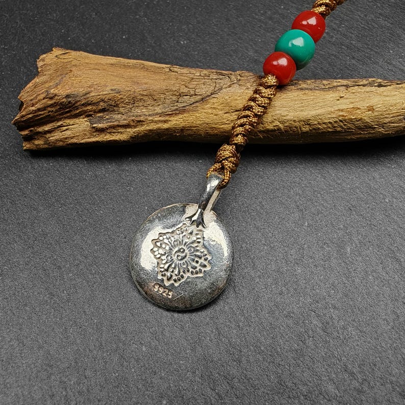 Calendar Badge,Melong Mirror, SIPAHO Amulet - Tibetan Buddhist amulet, close-up detail