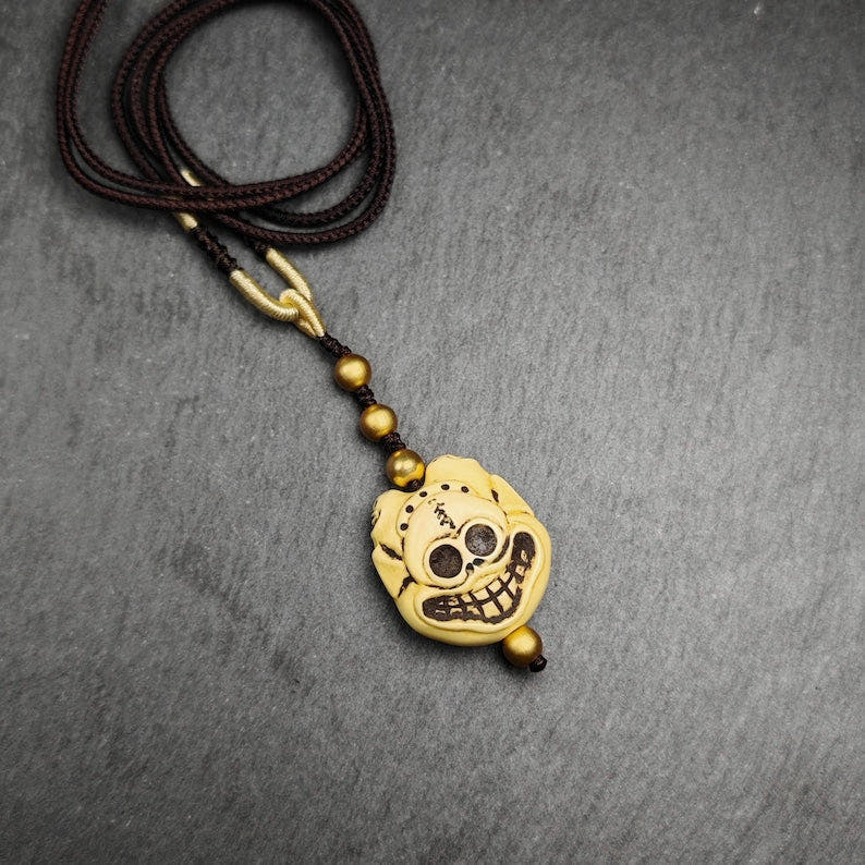 Tibetan Amulet,Citipati Skull Pendant,Made of Celluloid - Tibetan Buddhist amulet, front view