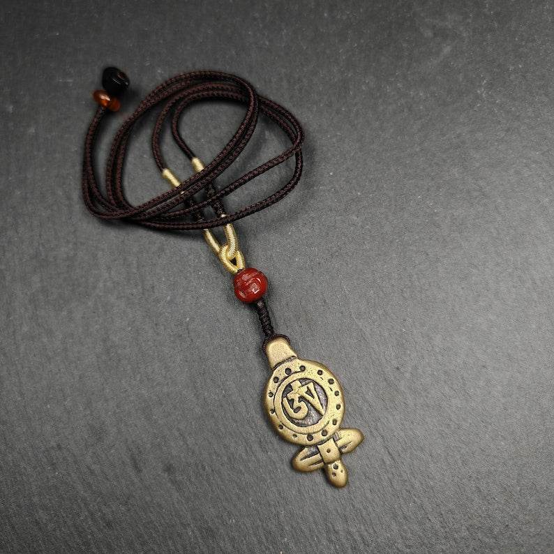 Tibetan Buddhism Amulet - Vajra Pendant with OM Symbol - Tibetan Buddhist amulet, close-up detail