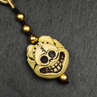 Tibetan Amulet,Citipati Skull Pendant,Made of Celluloid - Tibetan Buddhist amulet, detailed view