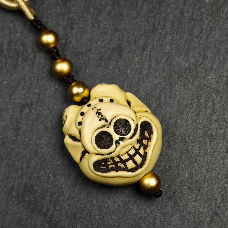 Tibetan Amulet,Citipati Skull Pendant,Made of Celluloid - Tibetan Buddhist amulet, detailed view