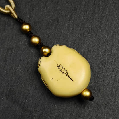 Tibetan Amulet,Citipati Skull Pendant,Made of Celluloid - Tibetan Buddhist amulet, close-up detail