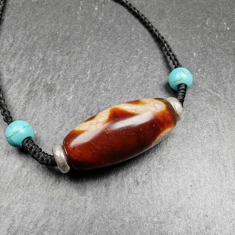 Fire Agate Lotus Dzi Amulet 31 - Tibetan dzi bead, close-up detail