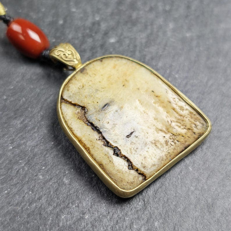 Shield-shaped Kapala Amulet - 33mm - Tibetan Buddhist amulet, close-up detail