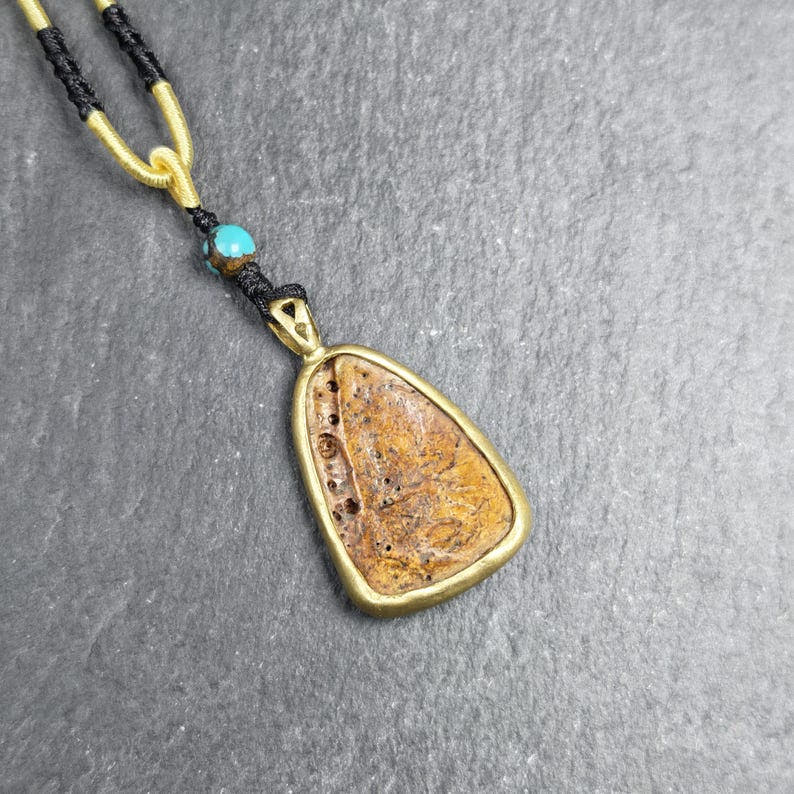 Shield-shaped Kapala Amulet - 33mm - Tibetan Buddhist amulet, detailed view