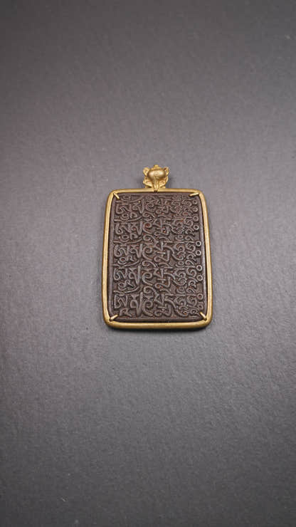 This badge is made by Tibetan craftsmen from Hepo Town, Baiyu County, the birthplace of the famous Tibetan handicrafts. It is made of thokcha, edging with copper, 2.76 × 1.77". The front is the OM mantra and the back is body, speech, and mind.