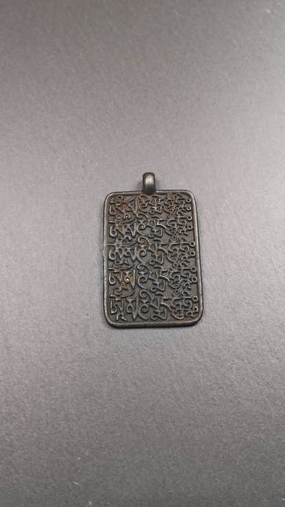 This badge is made by Tibetan craftsmen from Hepo Town, Baiyu County, the birthplace of the famous Tibetan handicrafts. It is made of copper, 2.52 × 1.57 inches. The front is the OM mantra and the back is body, speech, and mind.