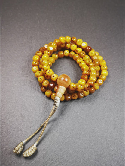 This mala bracelet was made by Tibetan craftsmen.  It is made of yak bone, yellow color,108 dice beads diameter of 7mm / 0.27",circumference is 68cm / 26.8" ,  end of a yak horn guru bead.