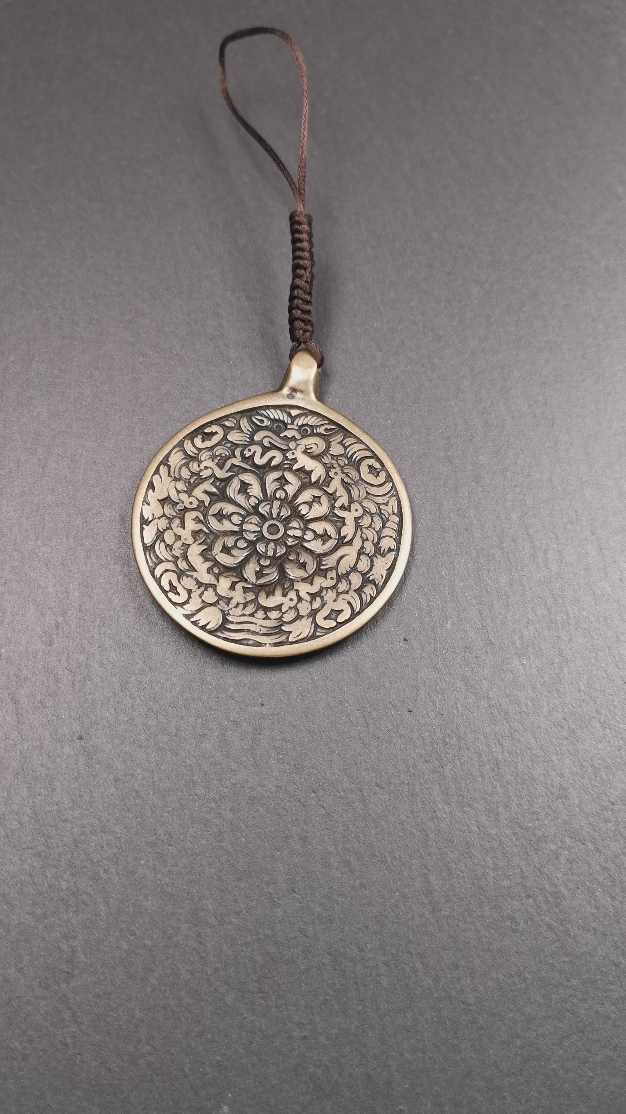 This unique meling amulet is handmade in Baiyu County Tibet,Where is the famous handicraft industry base in Tibetan areas.  It is made of lima brass,2.16 inches diameter,the front center is a very rare mandala flower shape.
