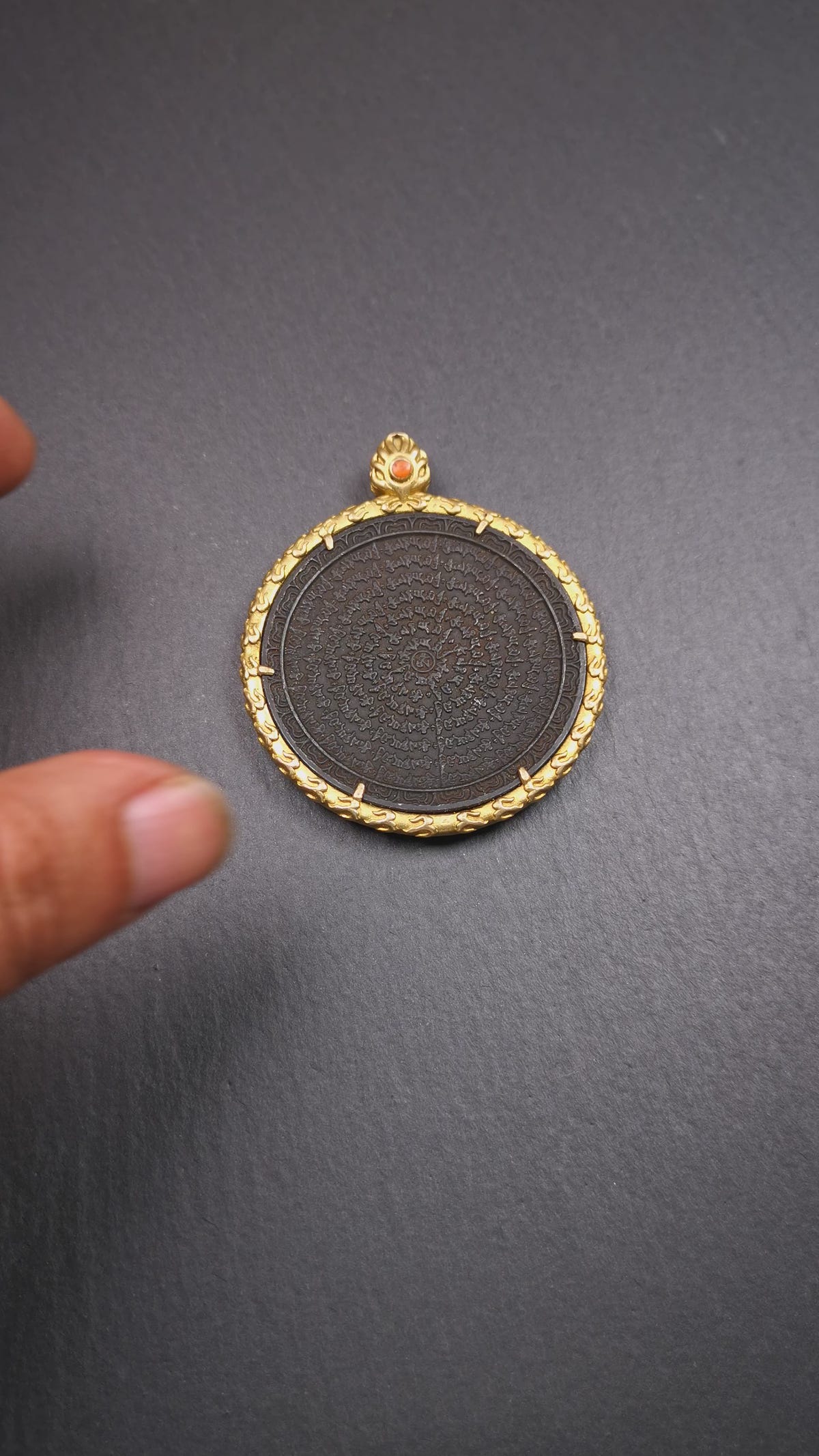 This badge is made by Tibetan craftsmen and come from Hepo Town, Baiyu County,Tibet. It is made of thokcha, edging with copper,round shape, 2.52 inche diameter. The OM MANI PADME HUM mantra arranged in concentric circles.