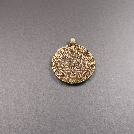 This Longevity Badge was handmade by Tibetan craftsmen and come from Hepo Town, Baiyu County, Tibet. It is made of brass,round shape,the theme is the god of longevity,surrounded by the symbols of Ashtamangala.