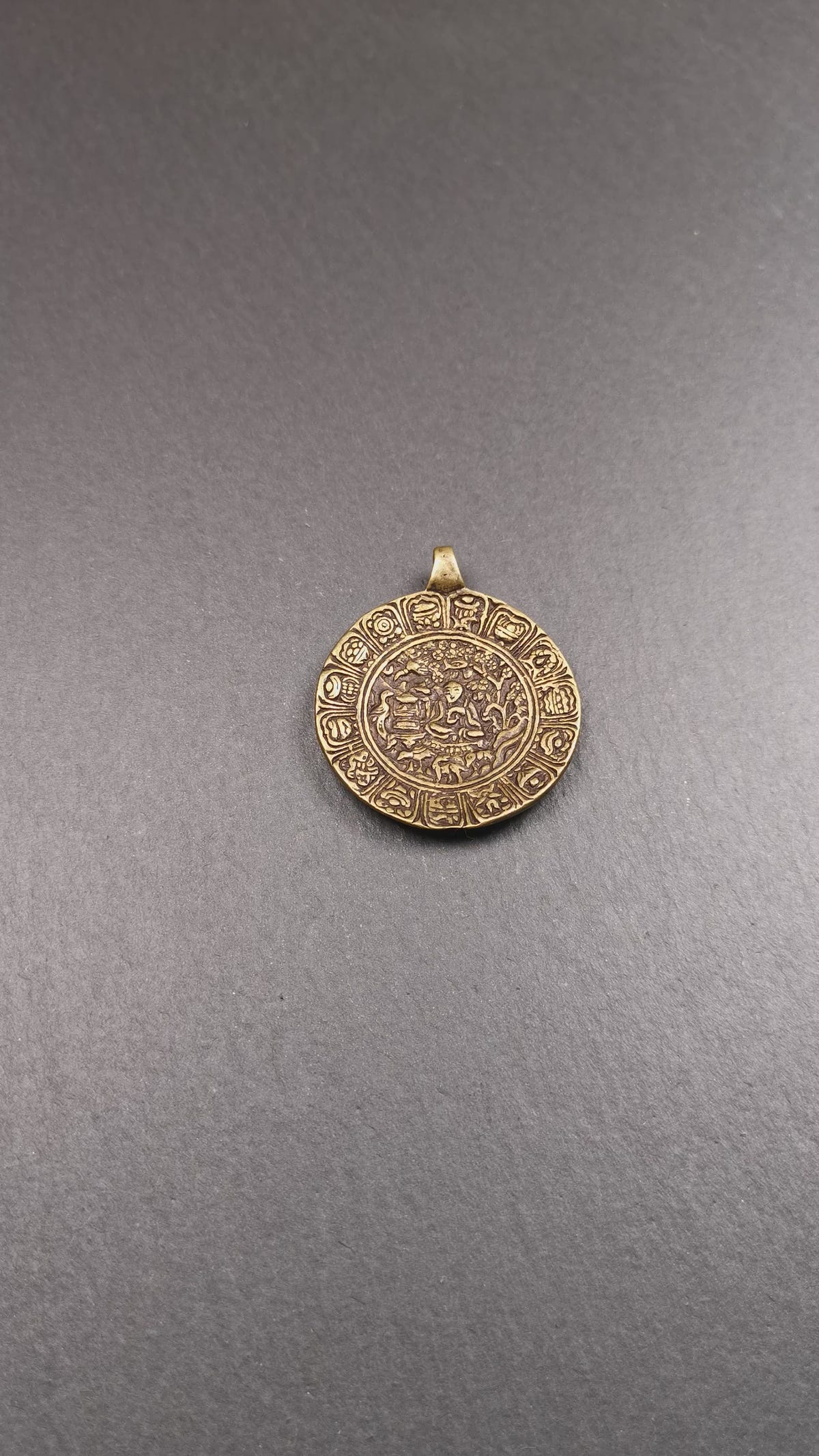 This Longevity Badge was handmade by Tibetan craftsmen and come from Hepo Town, Baiyu County, Tibet. It is made of brass,round shape,the theme is the god of longevity,surrounded by the symbols of Ashtamangala.