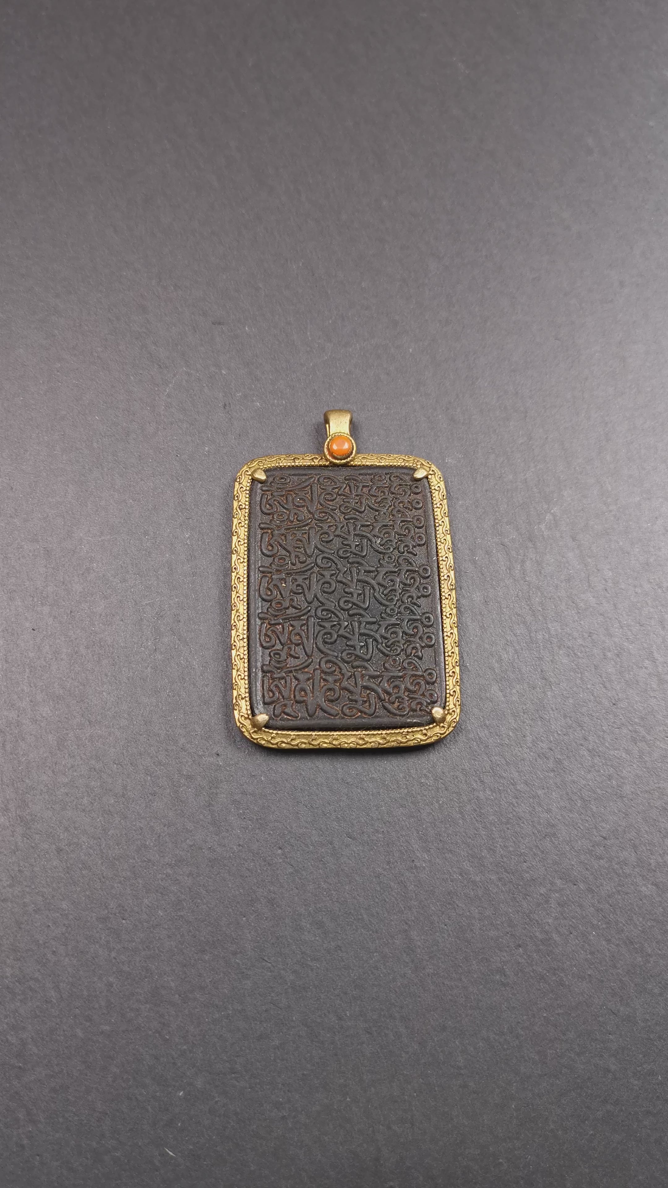 This badge is made by Tibetan craftsmen from Hepo Town, Baiyu County, the birthplace of the famous Tibetan handicrafts. It is made of copper, 2.52 × 1.57 inches. The front is the OM mantra and the back is body, speech, and mind.