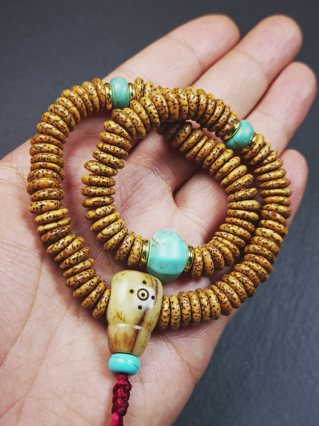 This flat lotus seed mala was collected from Gerze county,about 30 years old,hold and blessed by a lama. It is composed of 108 bodhi seed beads, flat cut shape,brown color,with 4 turquoise beads and 1 yak bone guru bead.