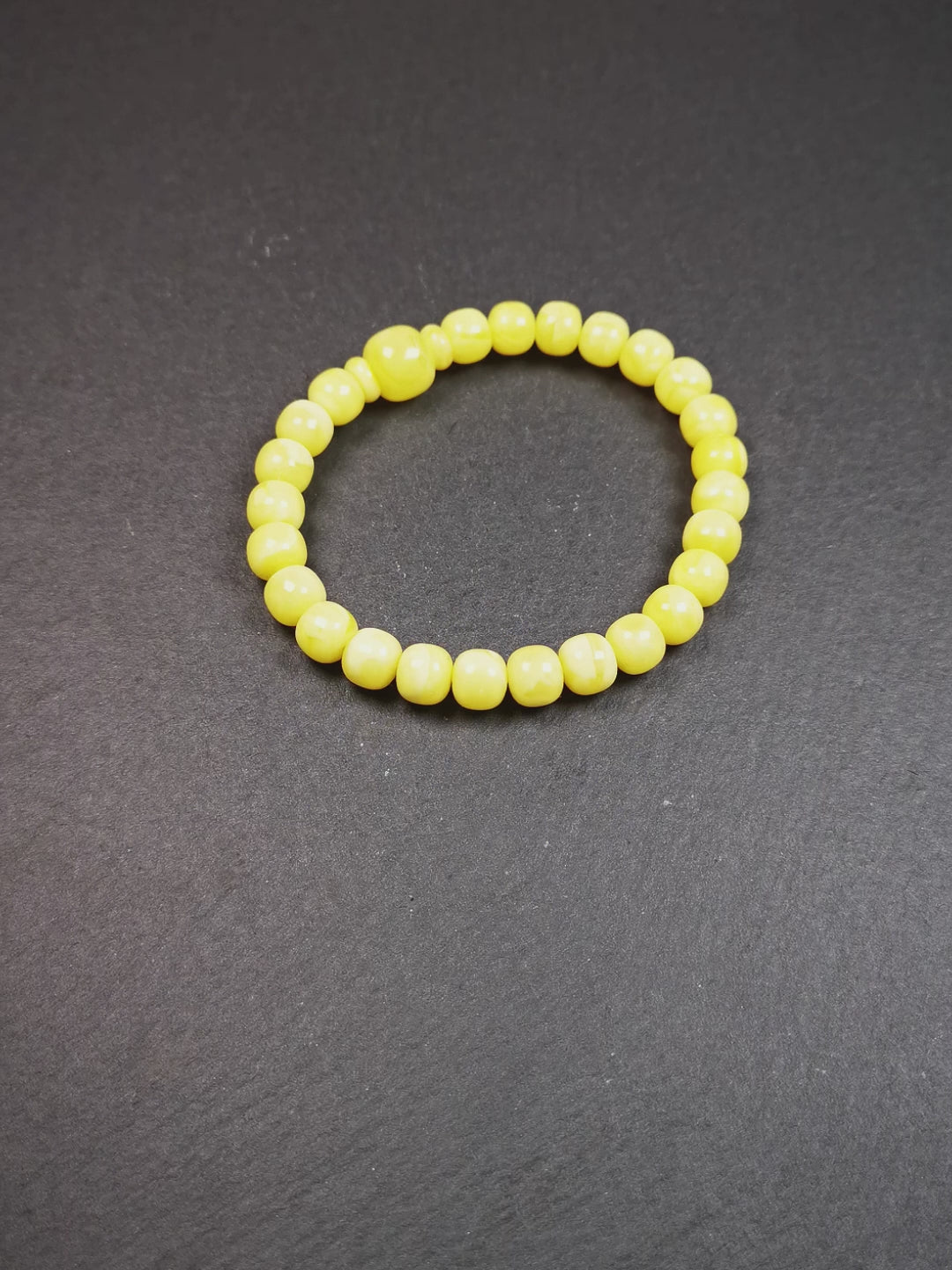 This amber beads bracelet was hand-woven by Tibetans from Baiyu County,Tibet. It is made of amber, yellow color,consists 1 main bead,25 small beads and 2 spacer beads,tie with elastic cord to fit your wrist.