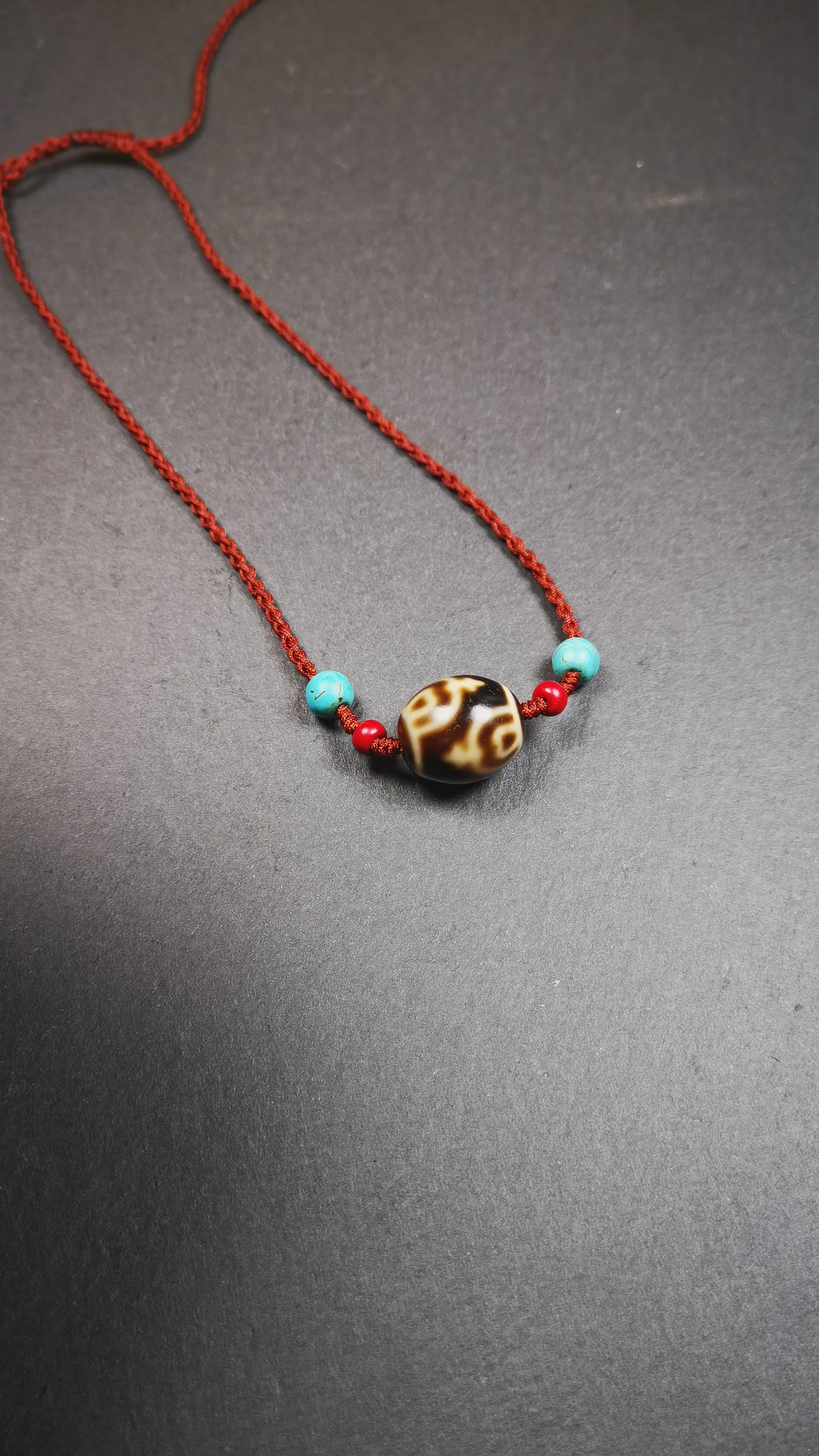 This necklace was hand-woven by Tibetans from Baiyu County, the main bead is a treasure vase dalo dzi, paired with 2 turquoise and 2 sharpa beads,about 30 years old. It can be worn as a fashionable accessory,holds cultural and religious significance.