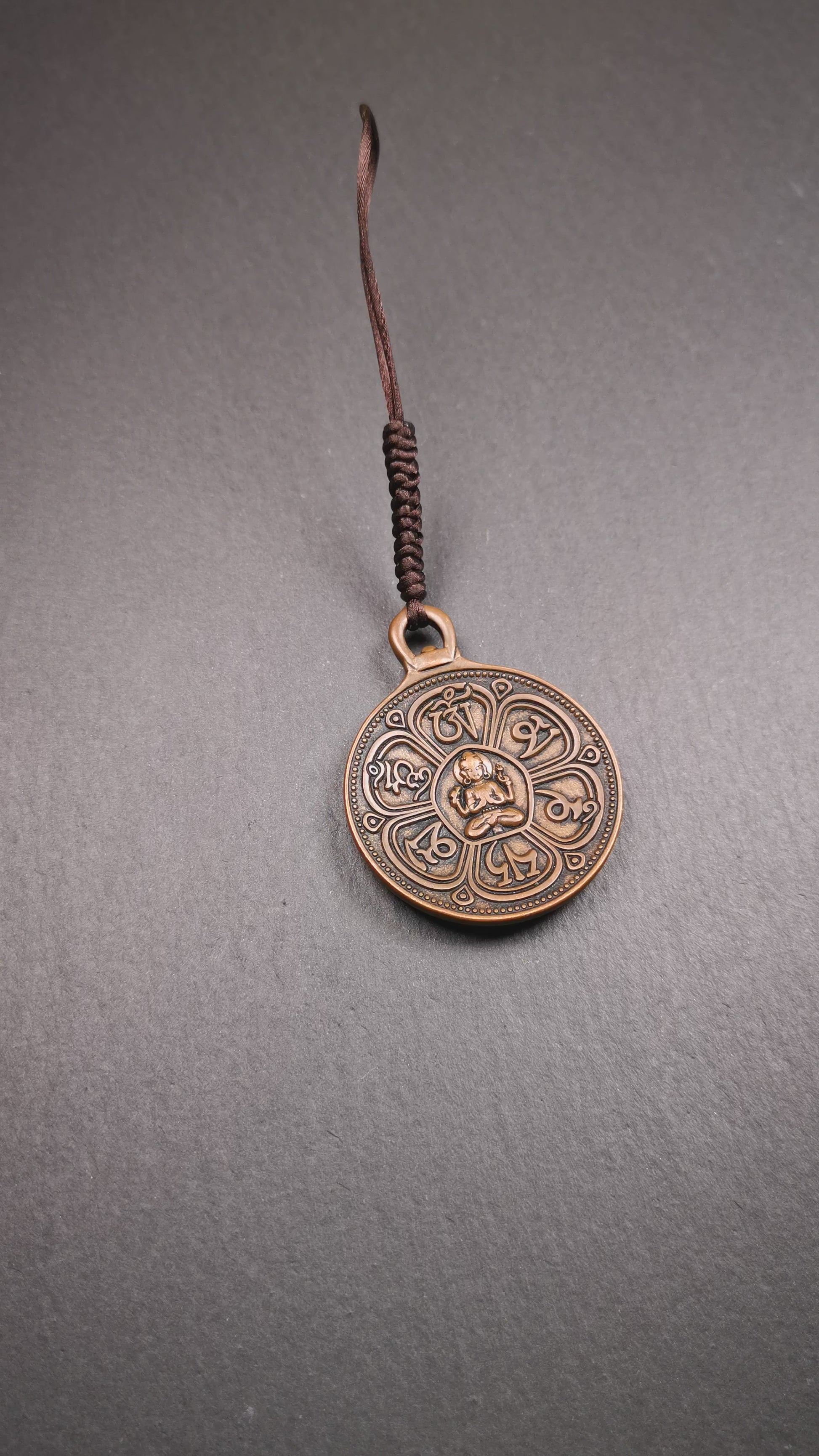 This OM badge amulet was collected from Jiegu Monastery Tibet.It is made of copper,diameter is 1.65 inches,Chenrezig is on the center, carved with Tibetan Letter ,Om Mani Padme Hum mantra,the letter on the back is Mind