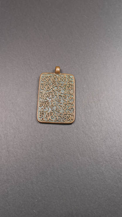 This badge is made by Tibetan craftsmen from Hepo Town, Baiyu County, the birthplace of the famous Tibetan handicrafts. It is made of copper, 2.44 × 1.42 inches. The front is the OM mantra and the back is body, speech, and mind.