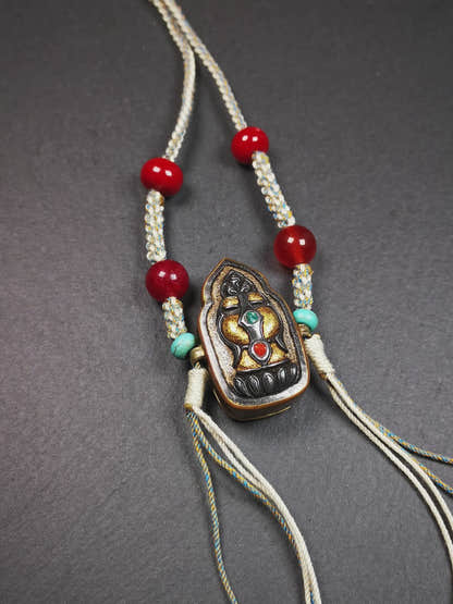 This portable Gau shrine was handcrafted by Tibetan artisans.  Its theme is mani jewel, a treasure vase on a lotus base, inside the vase are mani jewels and other jewels. Each exquisite pattern on it is meticulously hand-carved,and it is embellished with the technique of gold inlay, with cold iron and pure silver inlaid on the red copper material and gold-plated on the pure silver material,inlaid with turquoise and agate bead. 