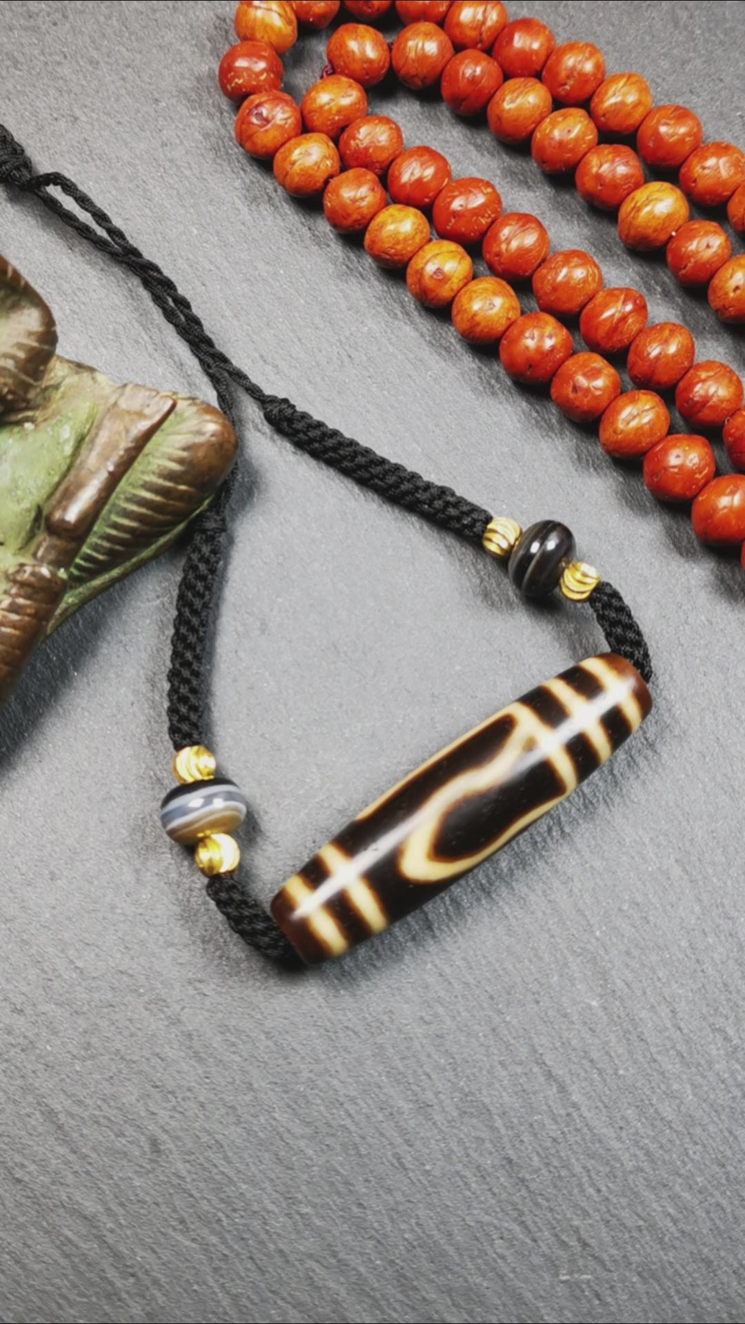 This necklace was hand-woven by Tibetans from Baiyu County, the main bead is a mountain eye dzi bead, paired with 2 small stripe dzi beads,about 30 years old. It can be worn not only as a fashionable accessory but also holds cultural and religious significance.