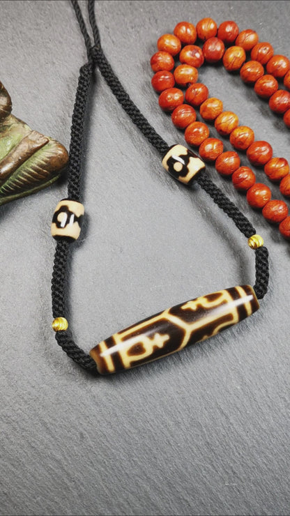 This necklace was hand-woven by Tibetans from Baiyu County, the main bead is a treasure vase dzi bead, paired with 3 eyed dzi beads,about 30 years old. It can be worn as a fashionable accessory, also holds cultural and religious significance.