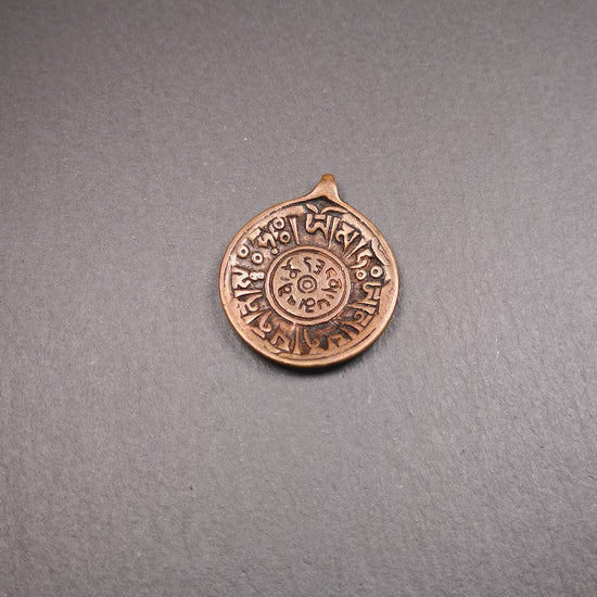 This Om badge amulet was collected from Yushu City Tibet,about 50 years old. It is round shape,made of lima brass, 1.46 inches,carved with mantra of chenrezig OM MANI PADME HUM. You can make it into a necklace, or a keychain, pendant