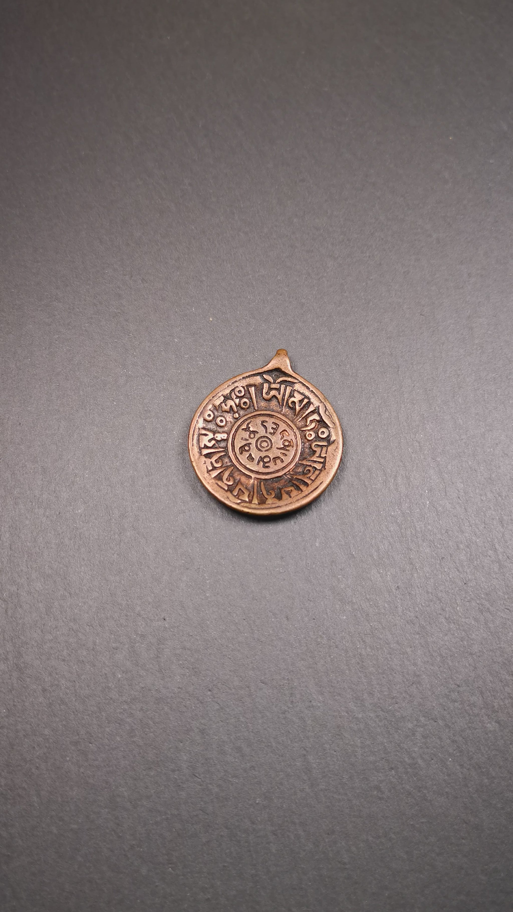 This Om badge amulet was collected from Yushu City Tibet,about 50 years old. It is round shape,made of lima brass, 1.46 inches,carved with mantra of chenrezig OM MANI PADME HUM. You can make it into a necklace, or a keychain, pendant