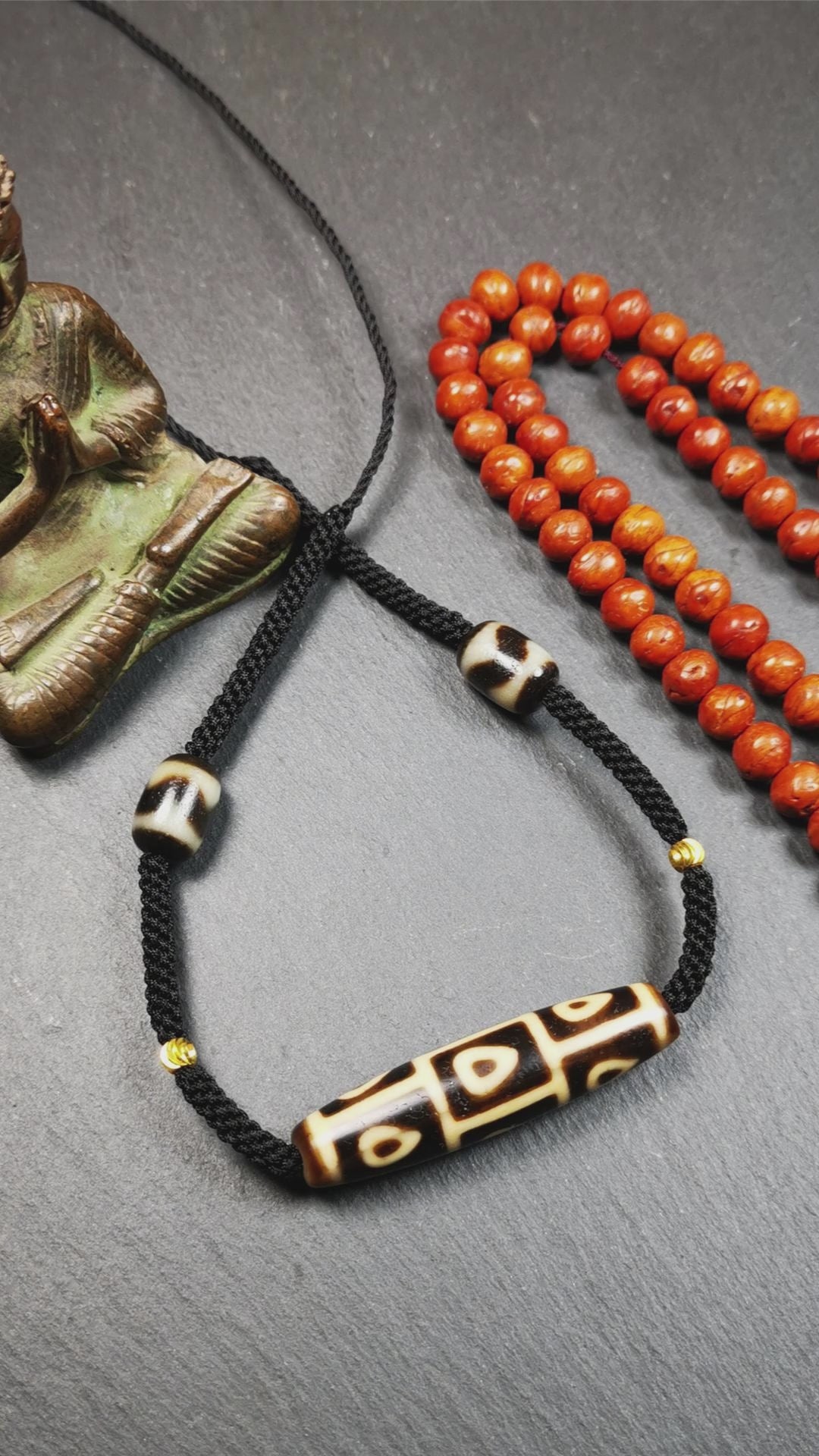 This necklace was hand-woven by Tibetans from Baiyu County, the main bead is a 9 eyed bodhi dzi bead, paired with 2 small tiger tooth dzi beads,about 30 years old. It can be worn as a fashionable accessory,holds cultural and religious significance.