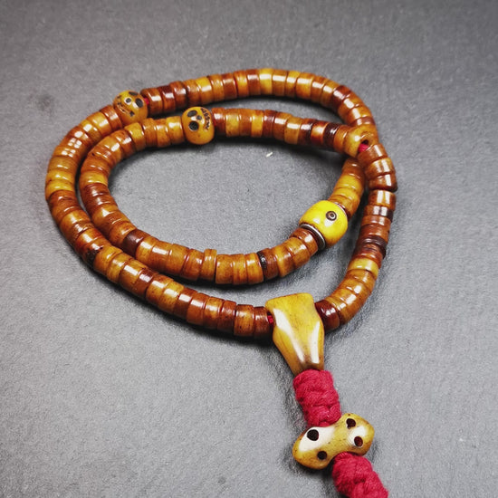This mala was made by Tibetan craftsmen,about 30 years old.  It is made of yak bone, brown color,108 beads diameter of 8.5mm / 0.34",circumference is 48cm / 18.9",include 3 spacer beads, 1 guru bead,and 1 bone vajra pendant.
