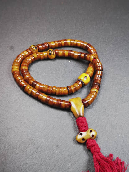 This mala was made by Tibetan craftsmen,about 30 years old.  It is made of yak bone, brown color,108 beads diameter of 8.5mm / 0.34",circumference is 48cm / 18.9",include 3 spacer beads, 1 guru bead,and 1 bone vajra pendant.