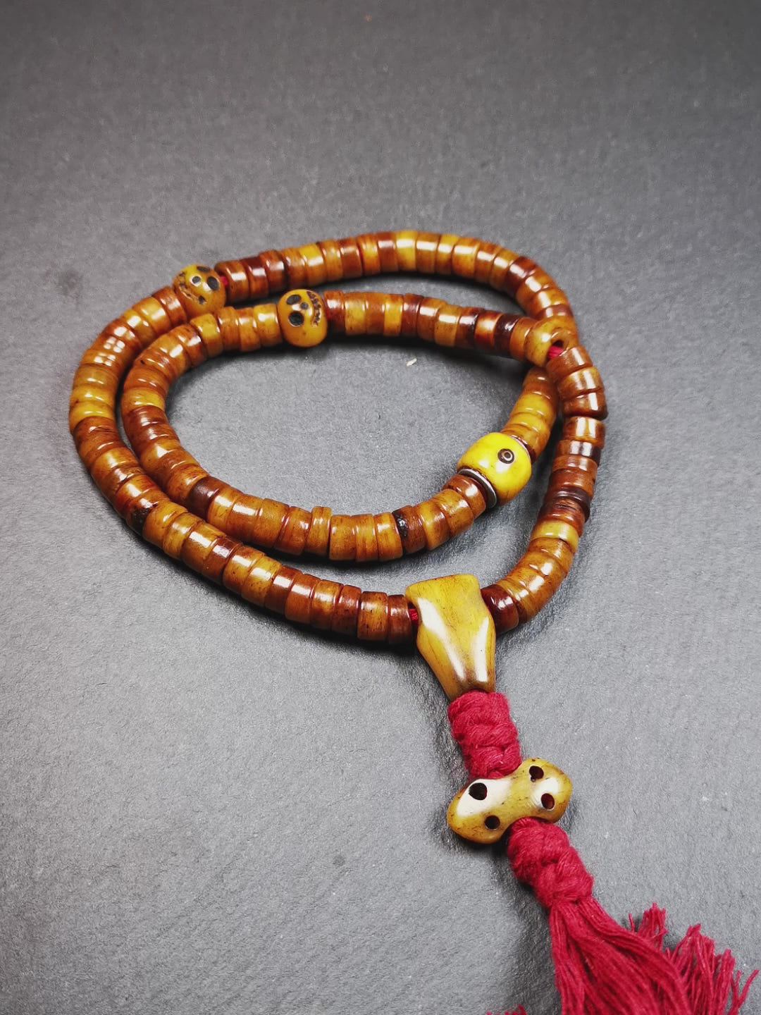 This mala was made by Tibetan craftsmen,about 30 years old.  It is made of yak bone, brown color,108 beads diameter of 8.5mm / 0.34",circumference is 48cm / 18.9",include 3 spacer beads, 1 guru bead,and 1 bone vajra pendant.