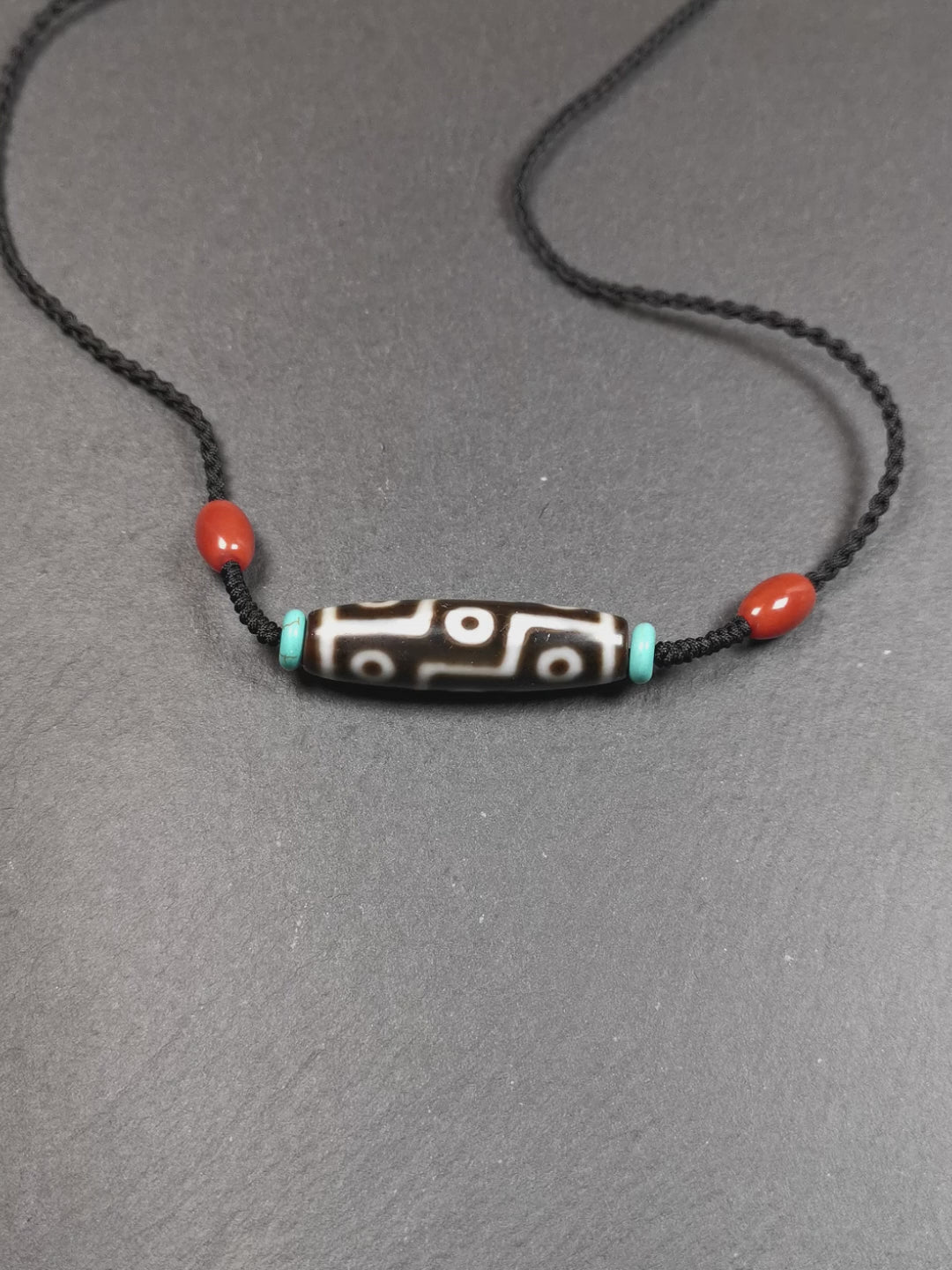 This 9 eyes dzi necklace was hand-woven by Tibetans from Baiyu County, the main bead is a 9 eyed  dzi bead, paired with 2 small agate beads and 2 turquoise spacer beads,about 30 years old.