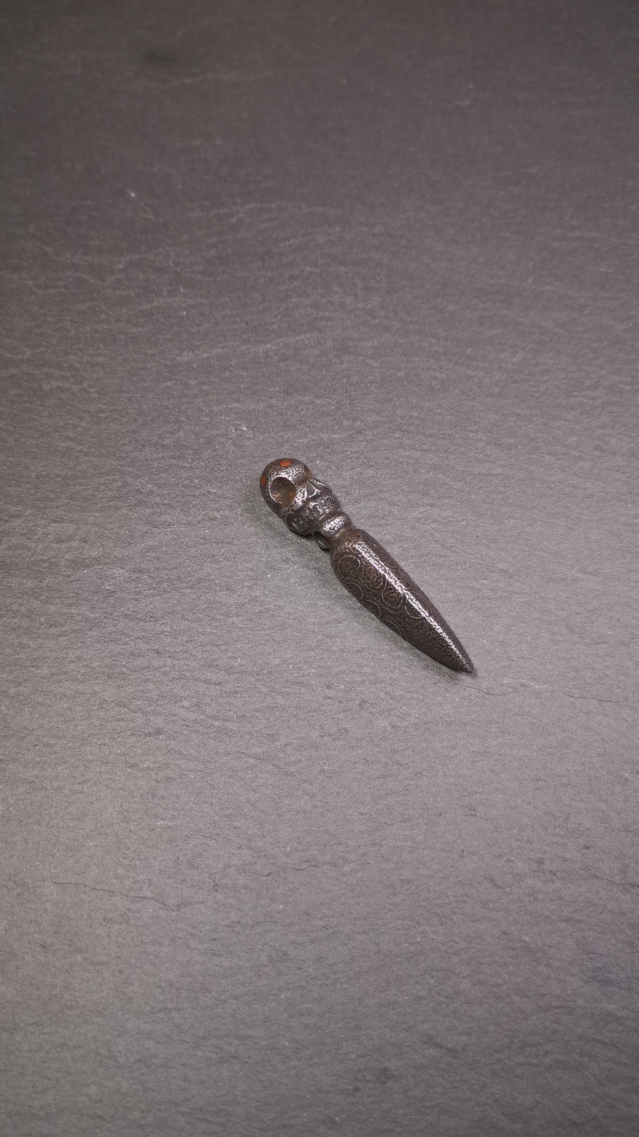 This phurba was made by Tibetan craftsmen and come from Hepo Town, Baiyu County, the birthplace of the famous Tibetan handicrafts. Its upper part is Shmashana Adhipati skull, the lower part is a Dorje Phurba, three copper dots inlaid on it
