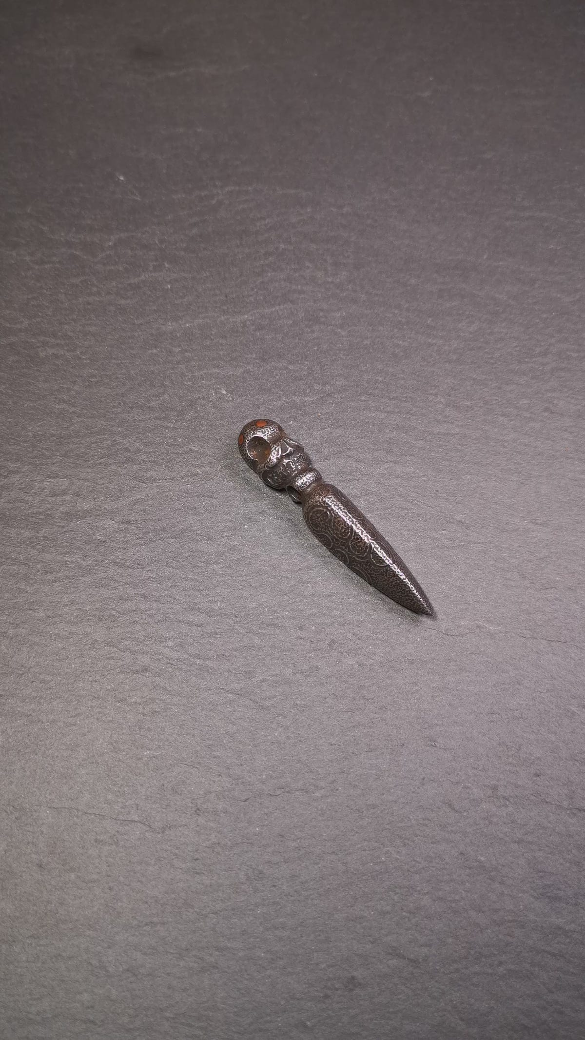 This phurba was made by Tibetan craftsmen and come from Hepo Town, Baiyu County, the birthplace of the famous Tibetan handicrafts. Its upper part is Shmashana Adhipati skull, the lower part is a Dorje Phurba, three copper dots inlaid on it