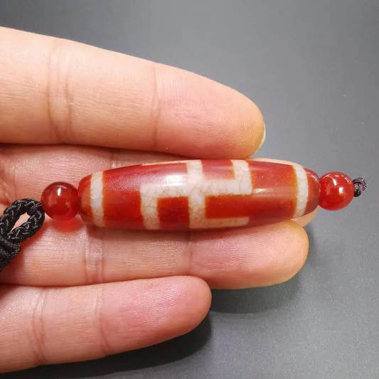Fire Agate Swastika Symbol 卐 Dzi Beads - Tibetan dzi bead, front view